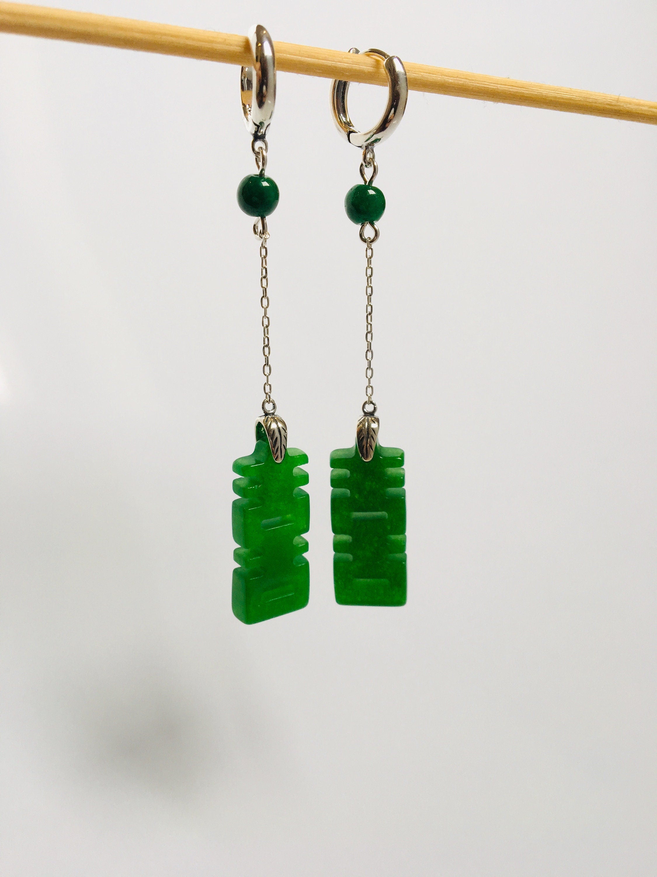 ront view of dark green jade earrings with long dangle and Chinese double happiness characters