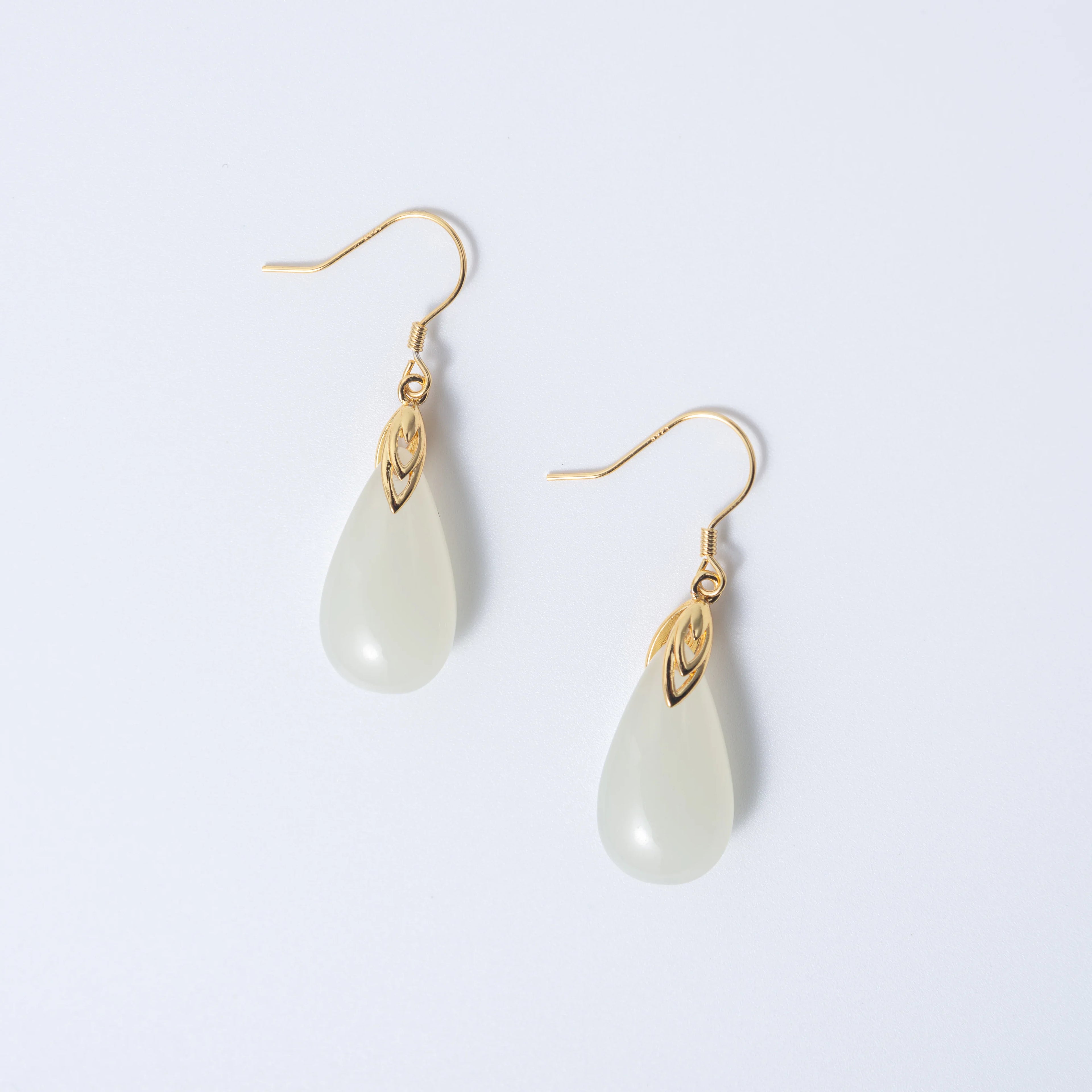 White teardrop jade earrings with soft natural finish and minimalist gold setting