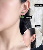 Green jade earrings being worn with close-up inset showing dangle and stud details.