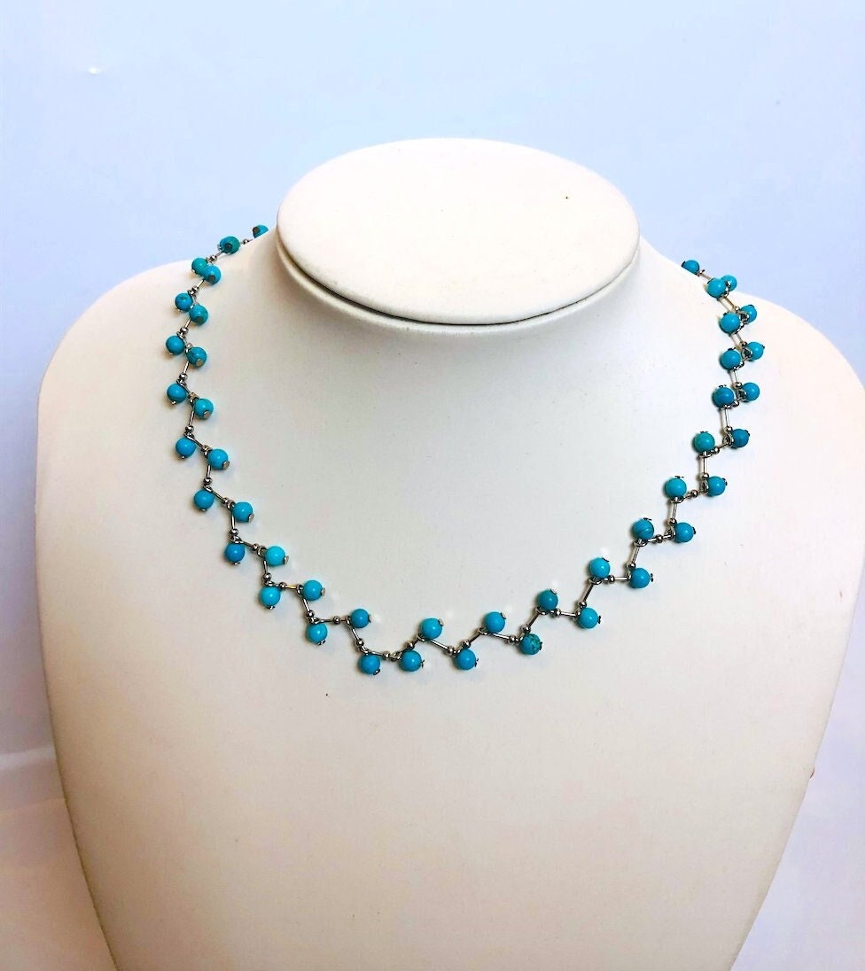 Side angle of blue turquoise seed bead necklace with 925 sterling silver zig zag necklace style