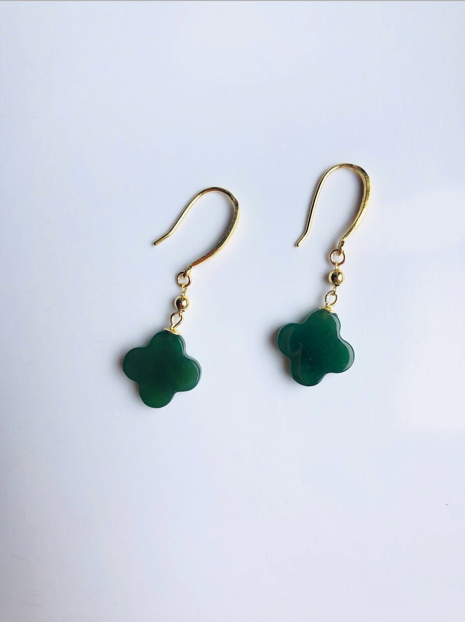 A pair of dark green jade clover earrings with 18k gold plating on the hooks, displayed against a white background.