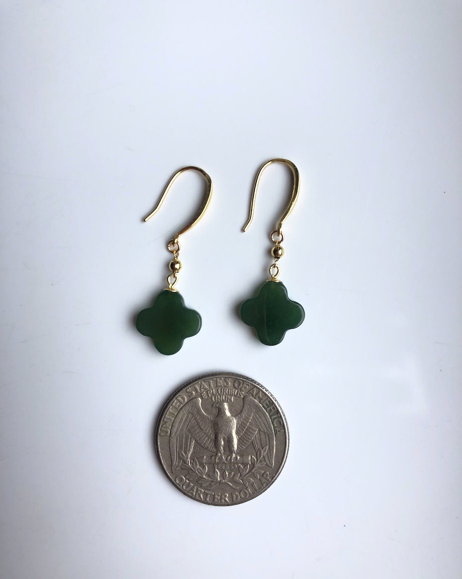 Clover jade earrings shown next to coin to display leaf charm size

