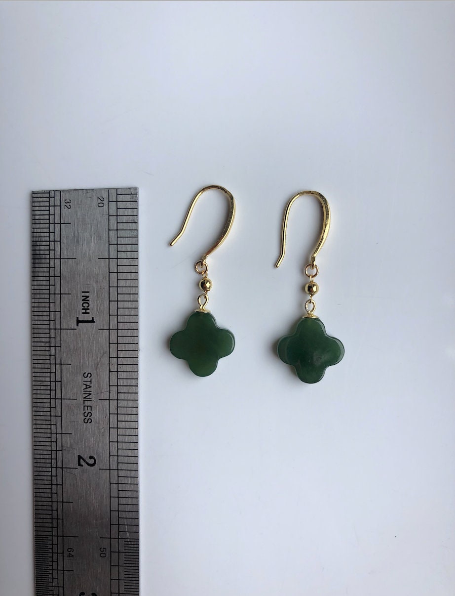 Clover jade earrings shown next to a ruler for size measurement