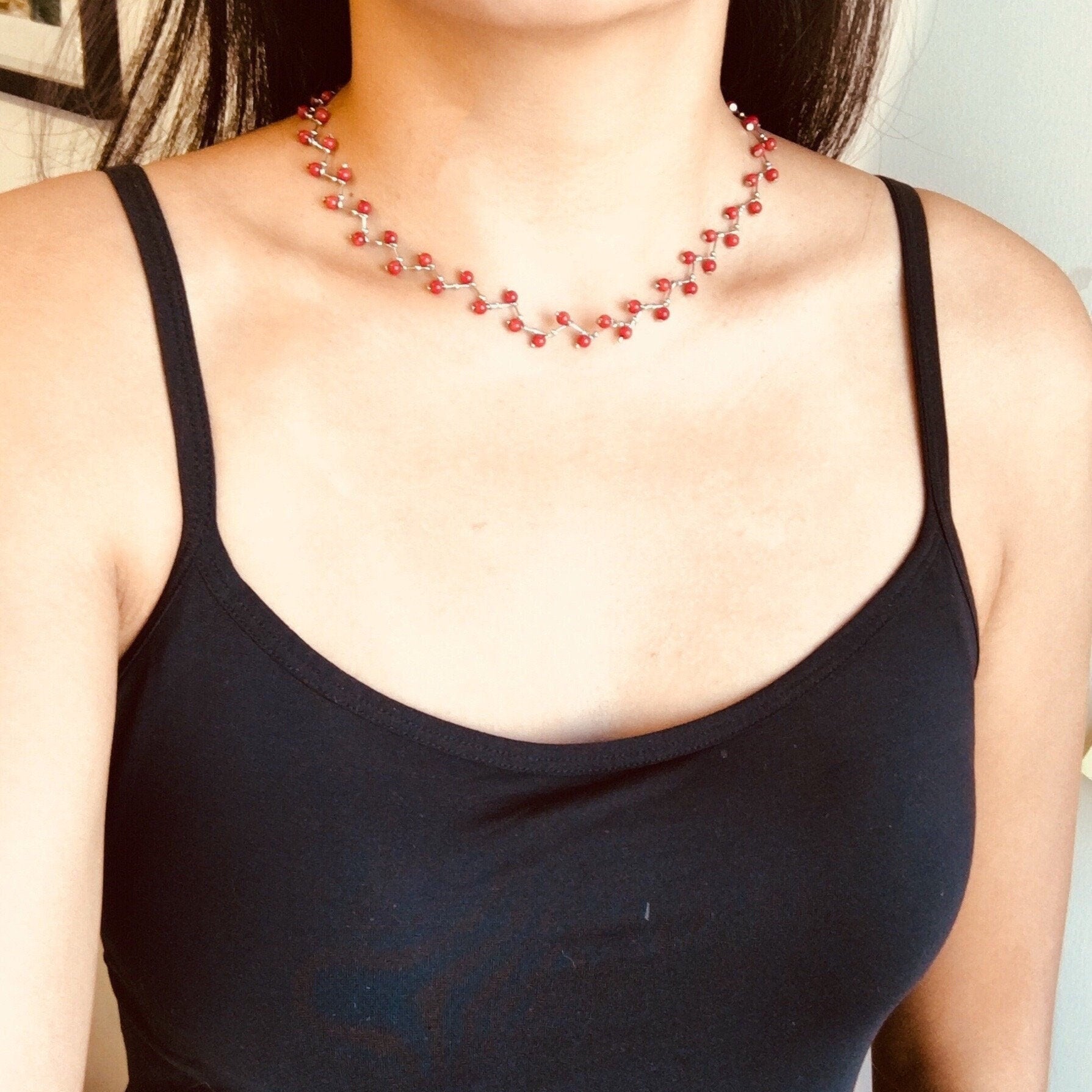 Model wearing coral and turquoise necklace with ruby silver choker detail and natural stone beads