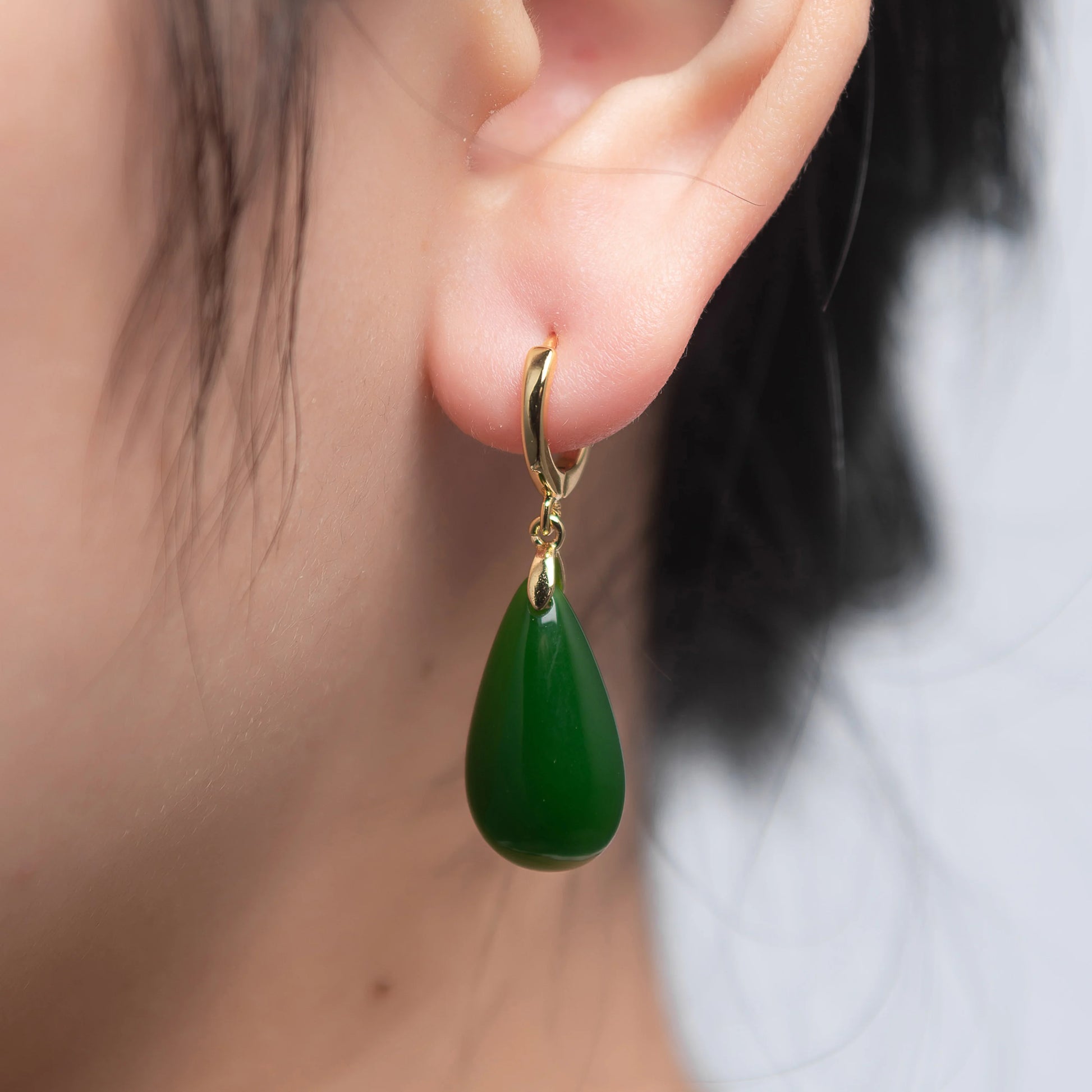 model wearing Vintage-style Chinese jade earrings in deep green with silver teardrop setting