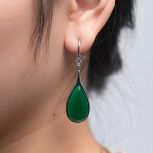 A girl wearing Dark green jade teardrop earrings made with 925 sterling silver and vintage Chinese design