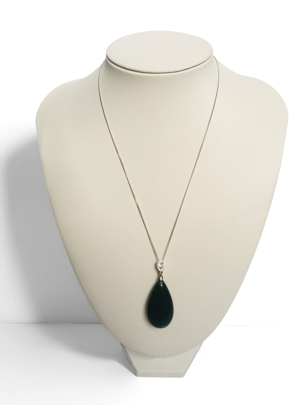Necklace with a green teardrop pendant on a mannequin bust against a white background