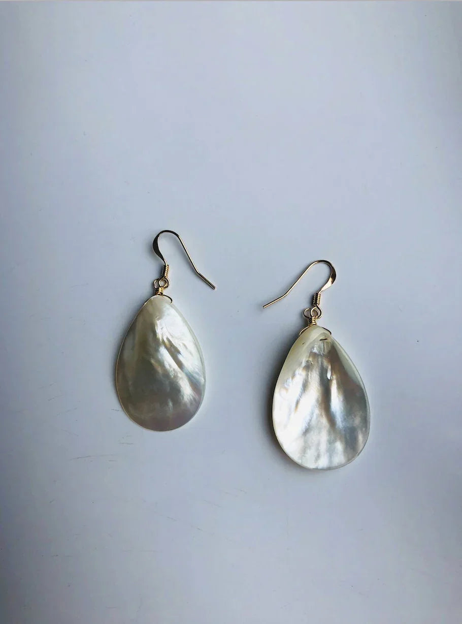 front and back Teardrop-shaped earrings on a light gray background
