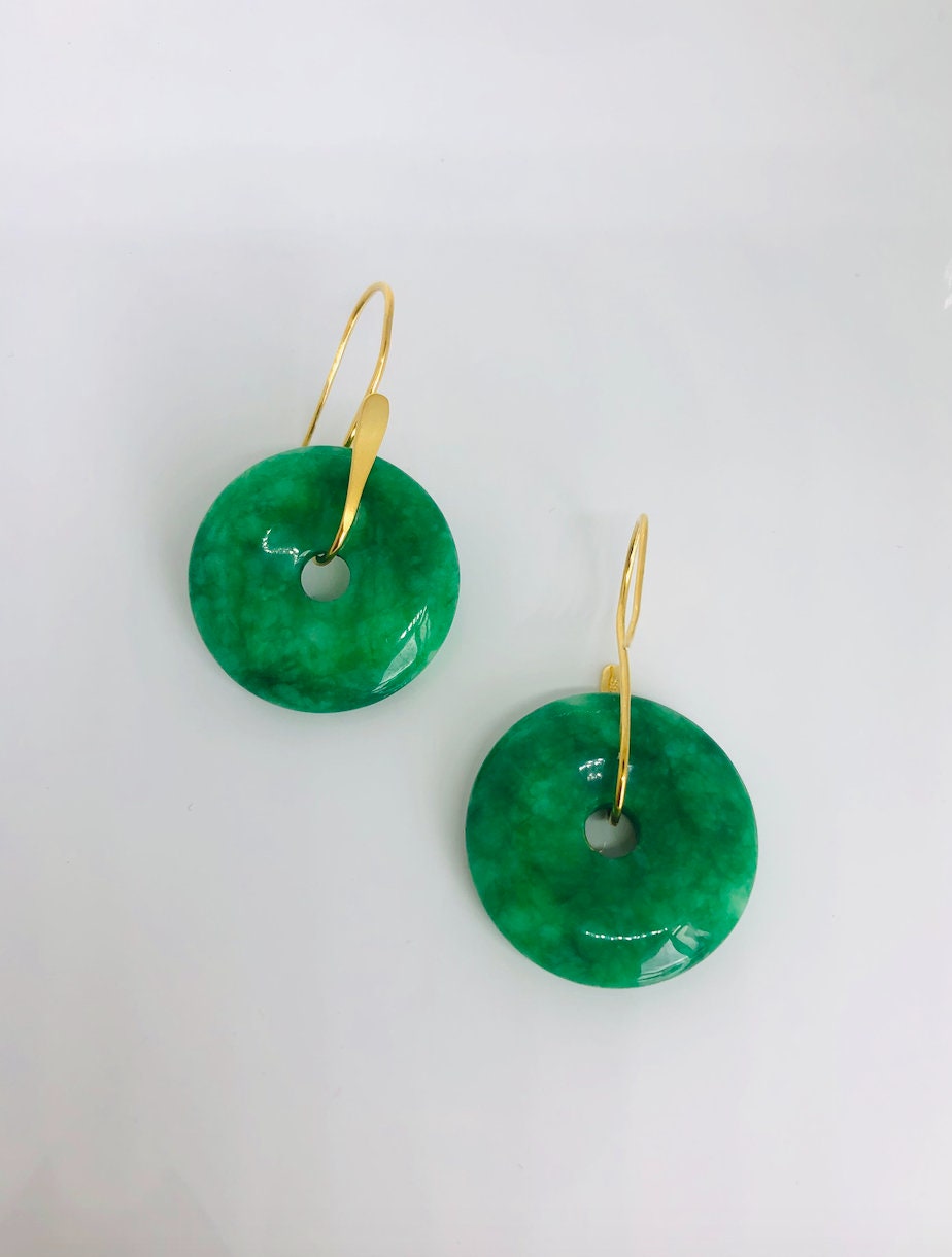 Front view of emerald green jade donut earrings with 18k gold hooks