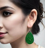 A modal wearing Emerald green jade earrings with 925 sterling silver vintage-style setting