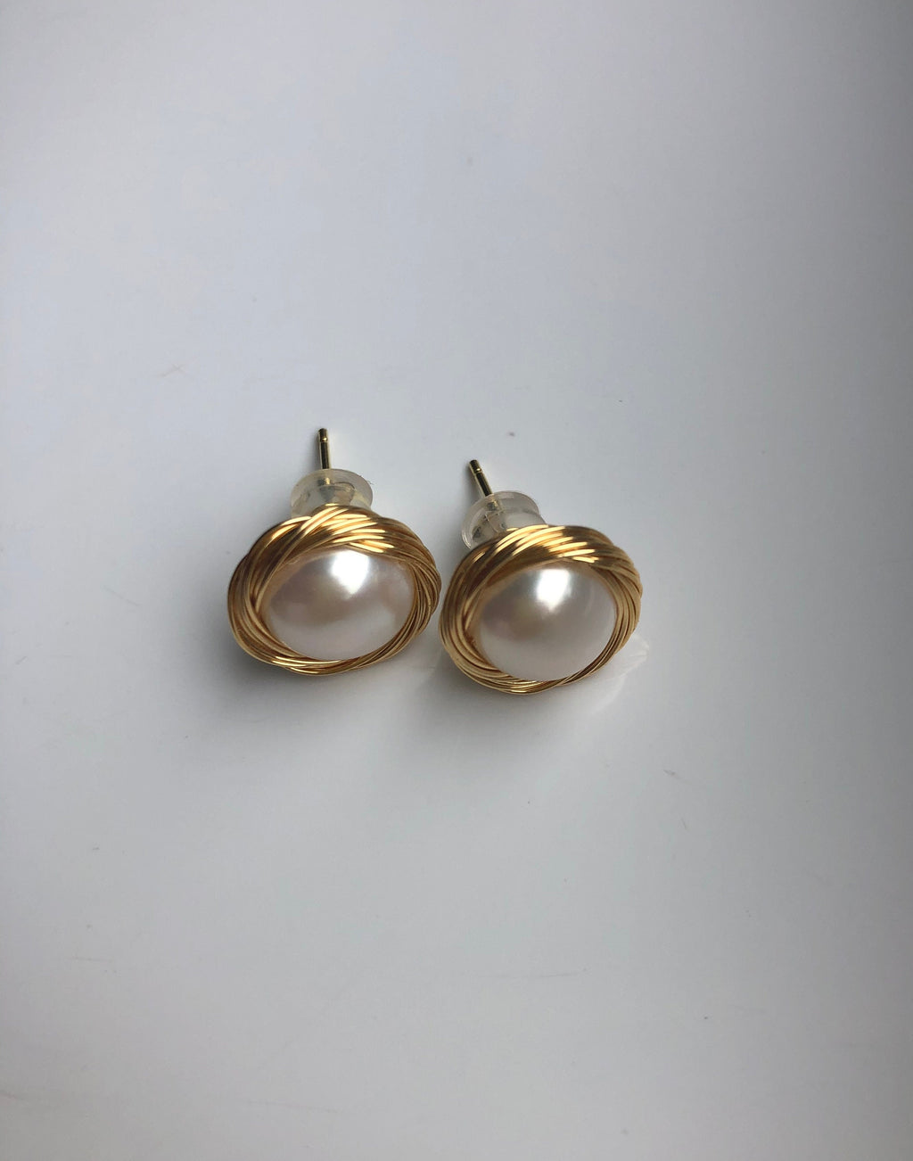 gold pearl stud earrings showing front and and back