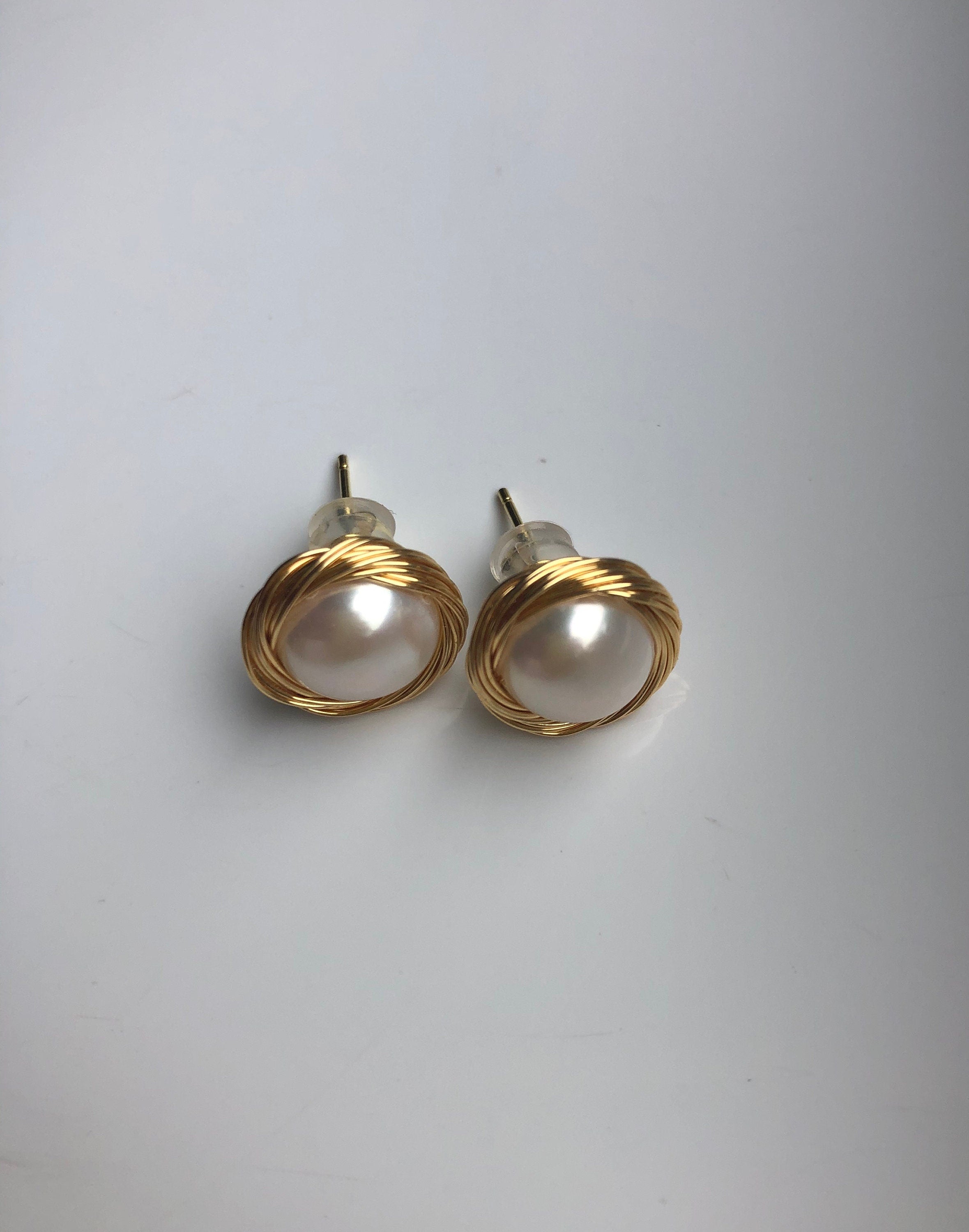 gold pearl stud earrings showing front and and back