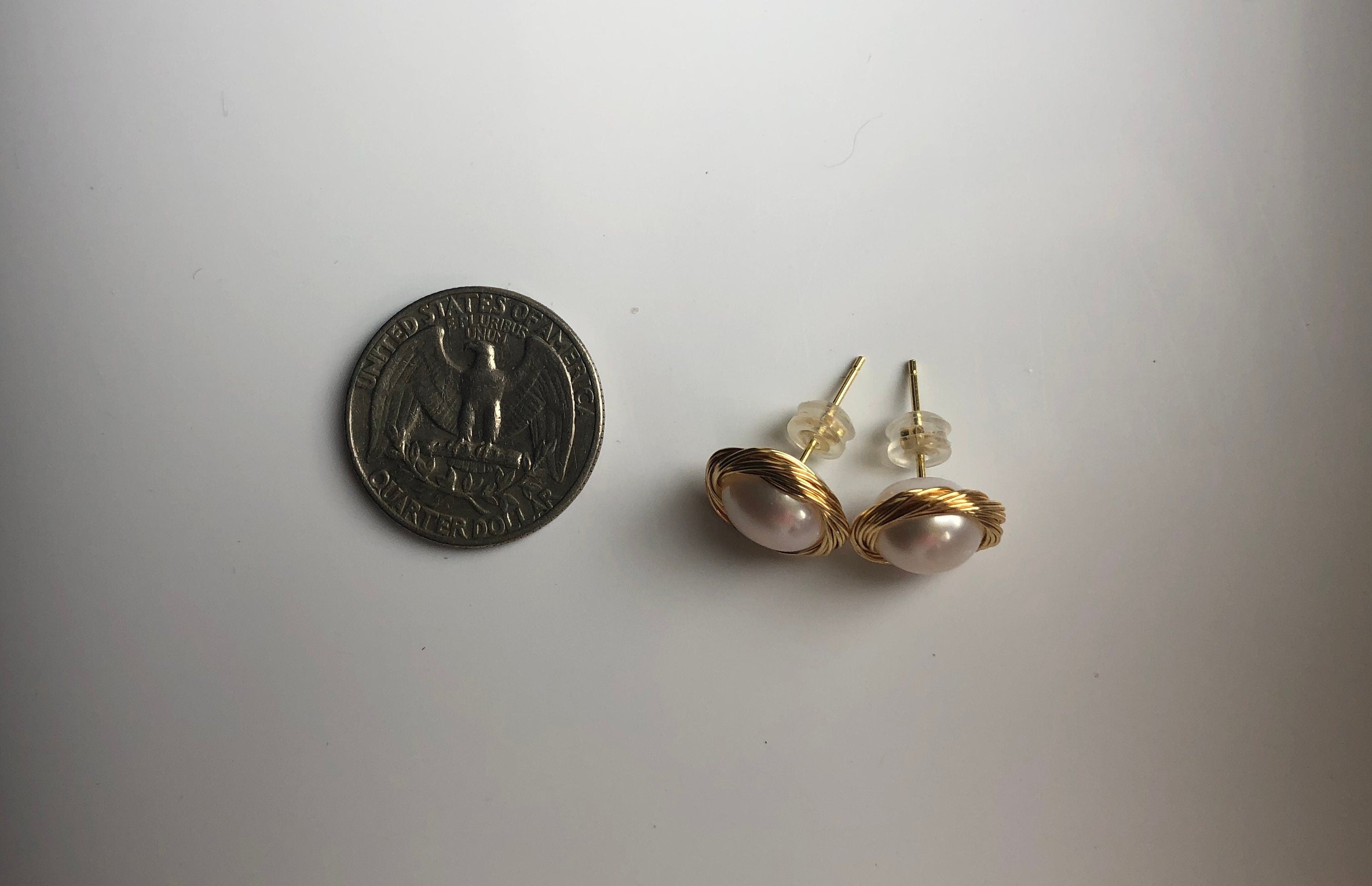 gold pearl stud earrings compare the size with a quater coin