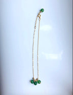 Gold-filled anklet with jade beads shown from side angle with focus on clasp and chain