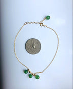 Green jade anklet with 14k gold-filled chain shown next to a US quarter coin for size reference