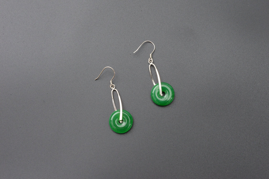 Front view of green jade donut earrings with sterling silver hooks and polished finish