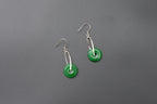 Front view of green jade donut earrings with sterling silver hooks and polished finish
