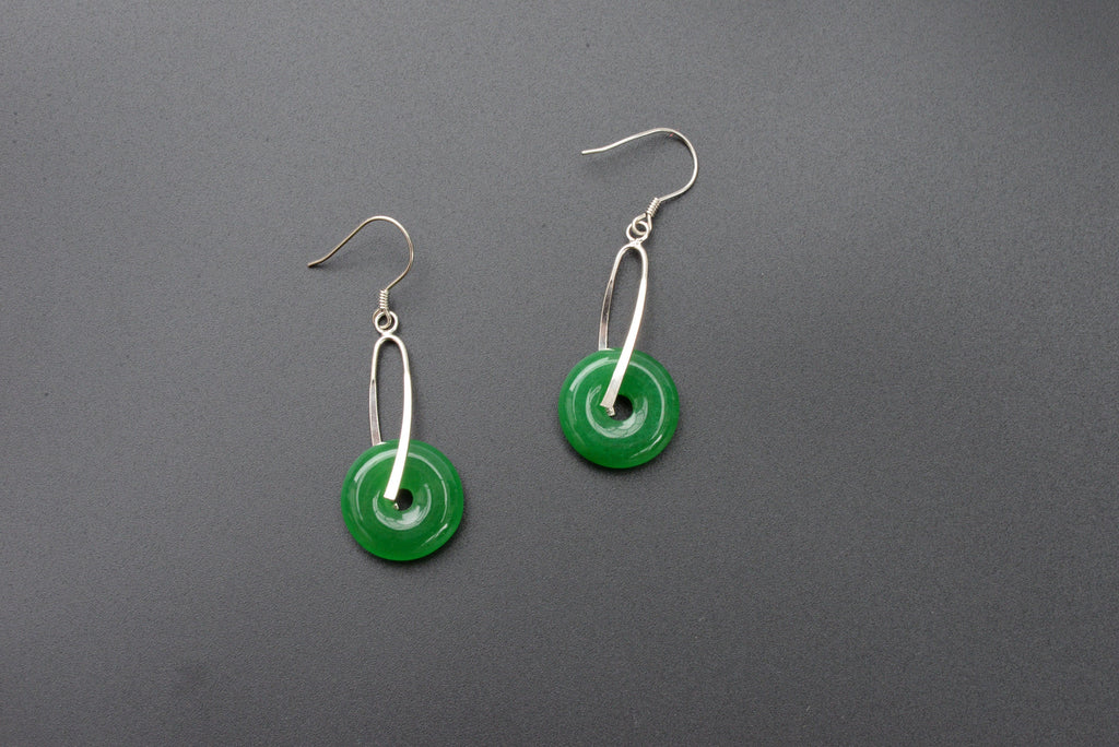 Front view of green jade donut earrings with sterling silver hooks and polished finish