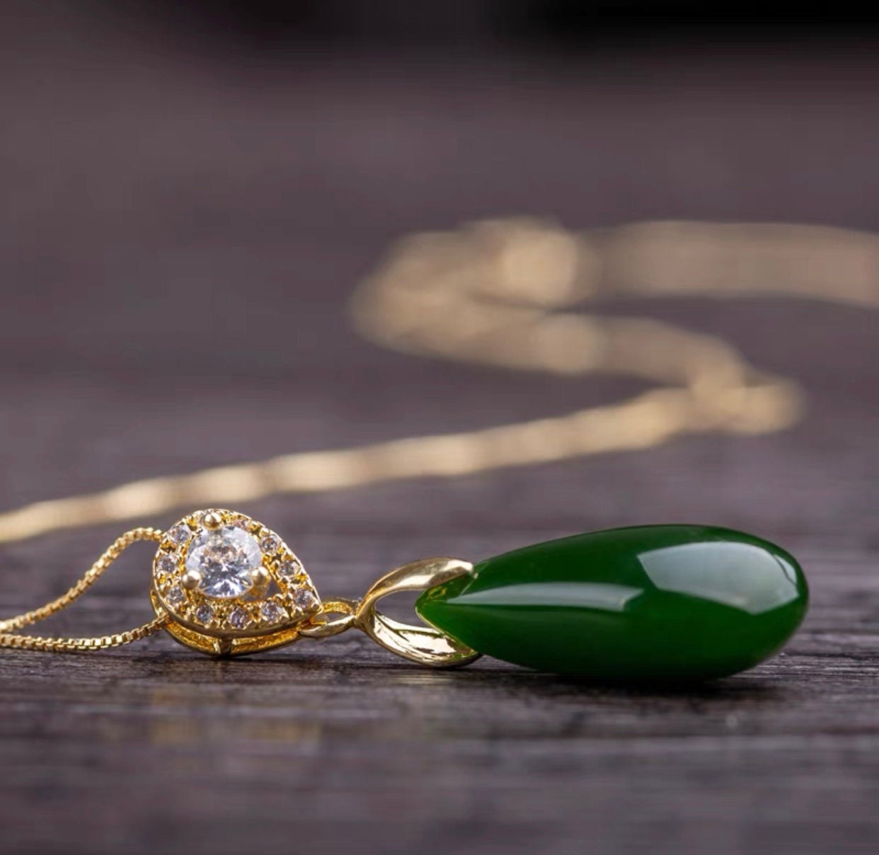 Green jade teardrop pendant necklace on gold chain, side view