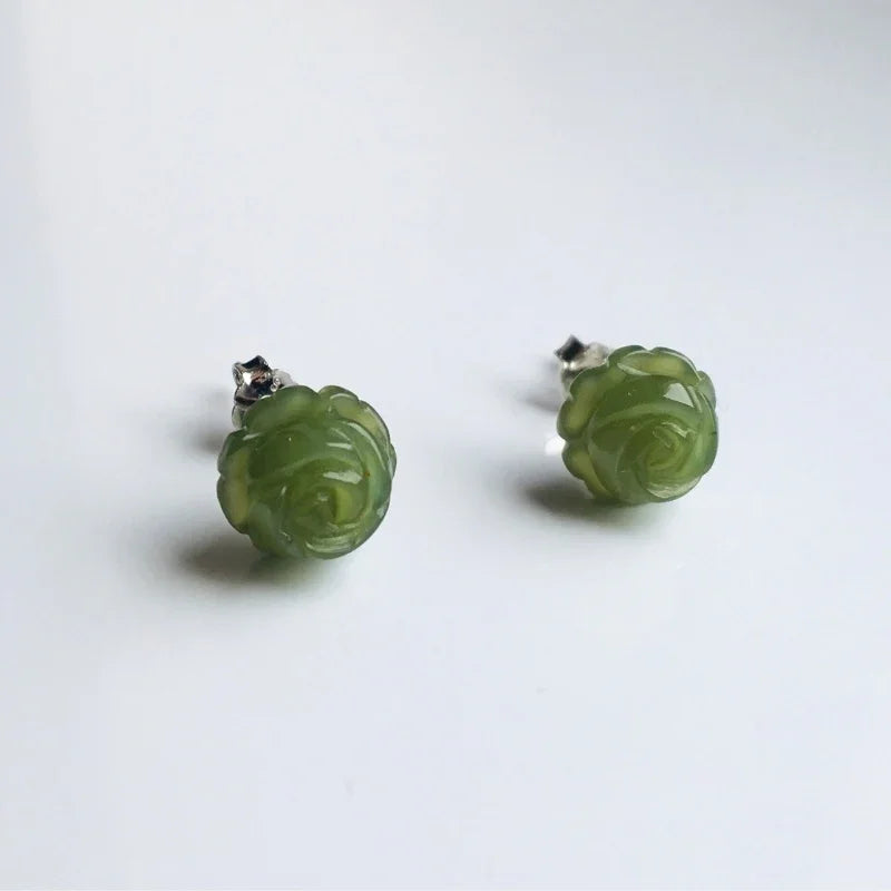 Green jade rose earrings viewed from side to show depth and carving detail of floral studs