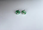 Side angle of tiny jade stud earrings showing gemstone depth and silver posts