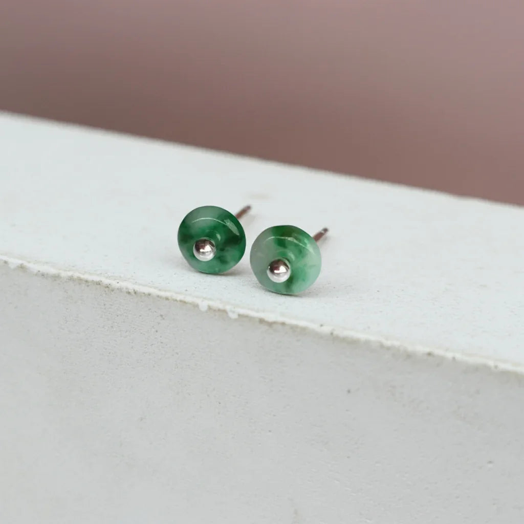 Side view of natural green jade stud earrings with silver settings