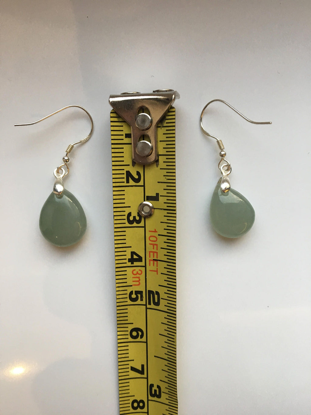 the jade earrings measured by a tape