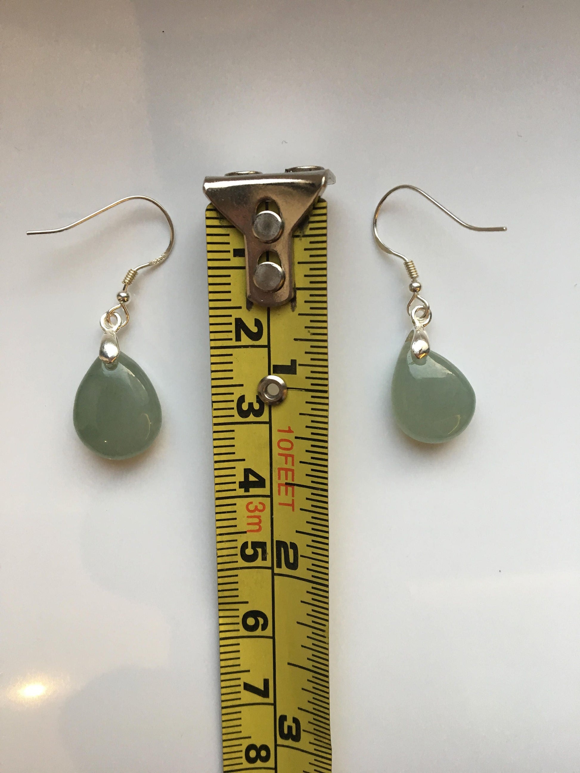 the jade earrings measured by a tape
