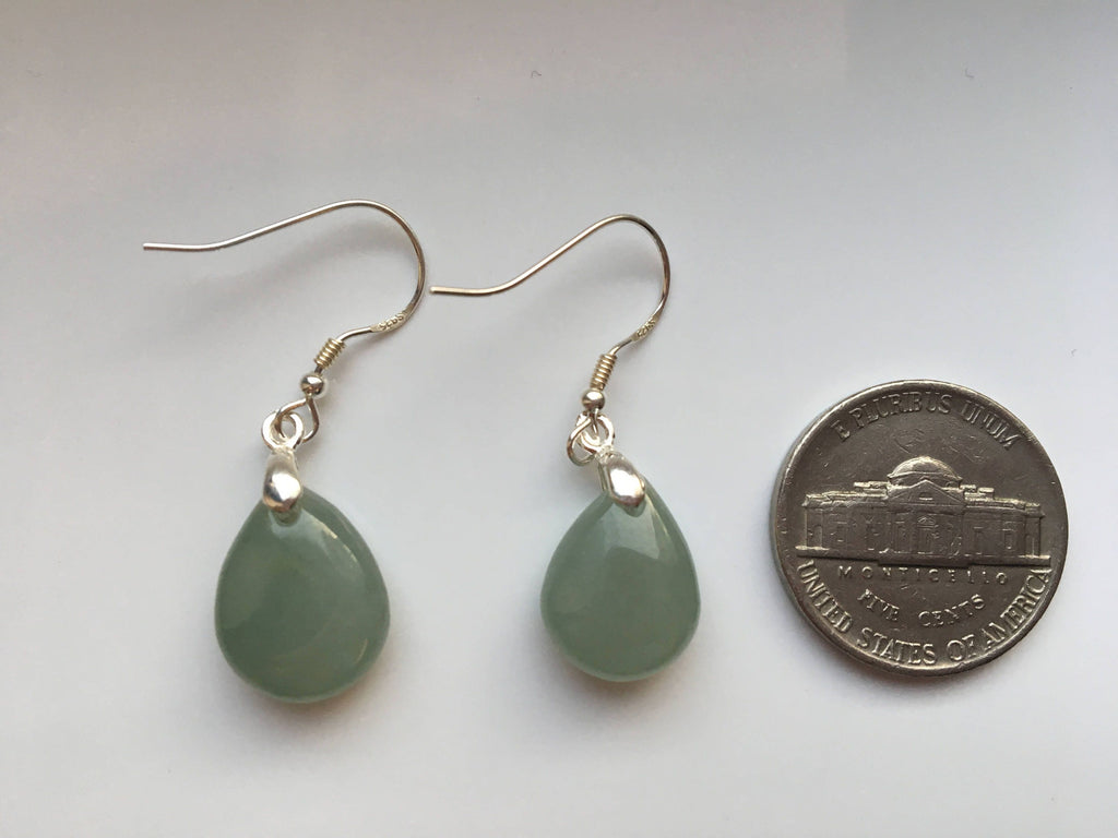the green jade earrings compare with a coin for size reference