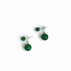 Pair of green jade earrings on a white background