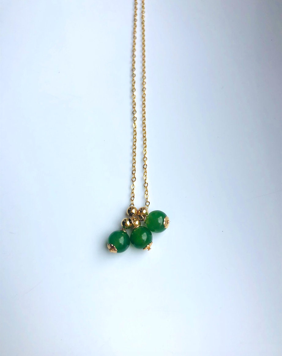 Close-up of green jade beads and 14k gold-filled chain showing texture and craftsmanship