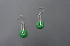 Side view of round Chinese jade earrings showing donut shape and silver dangle setting