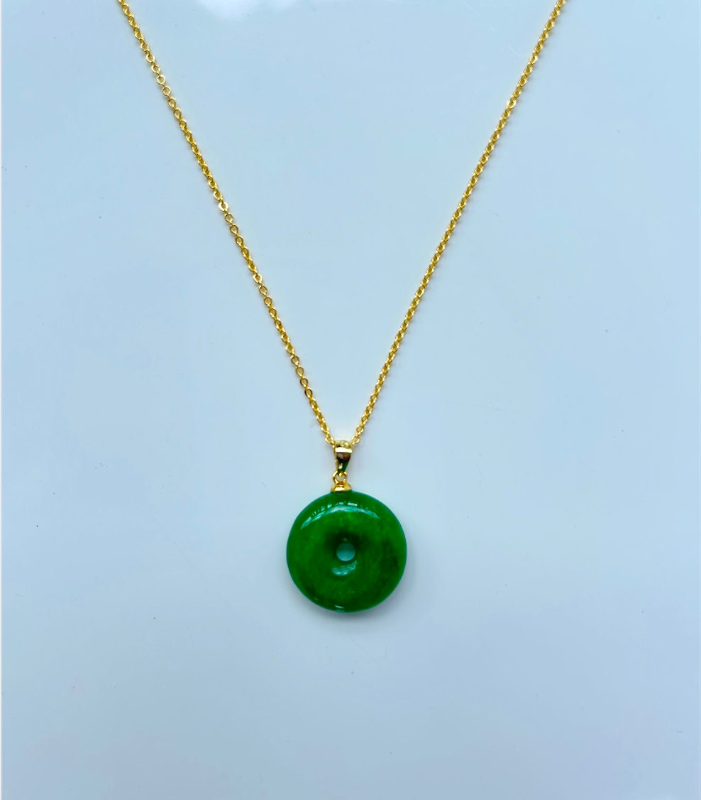 Front view of minimalist green jade donut necklace with 18k gold chain on a white background