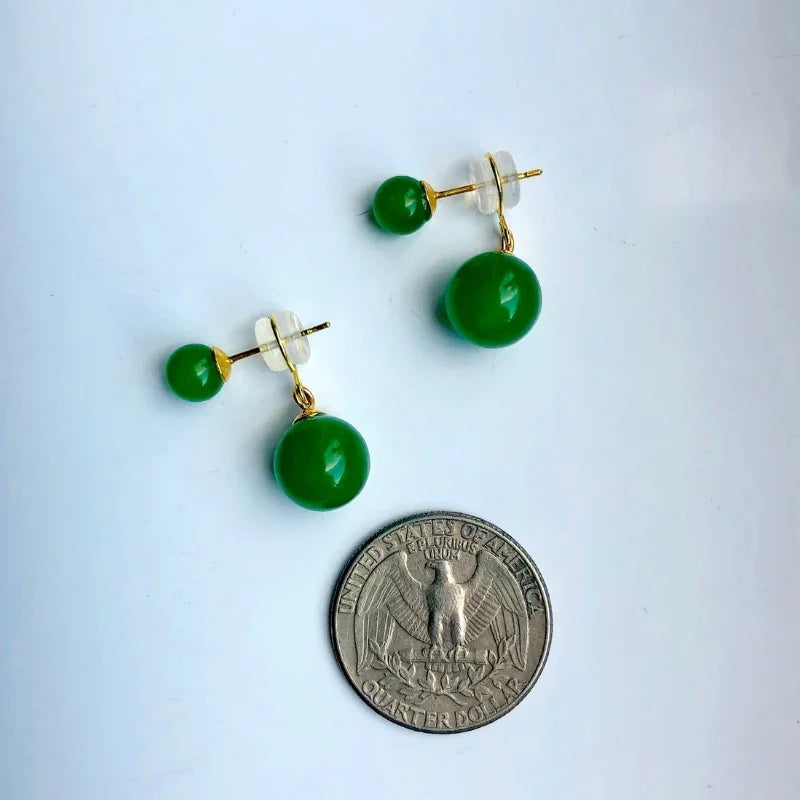 Green bead earrings with gold posts on a white background, shown with a quarter for scale.