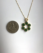 Size comparison of jade pendant next to a coin