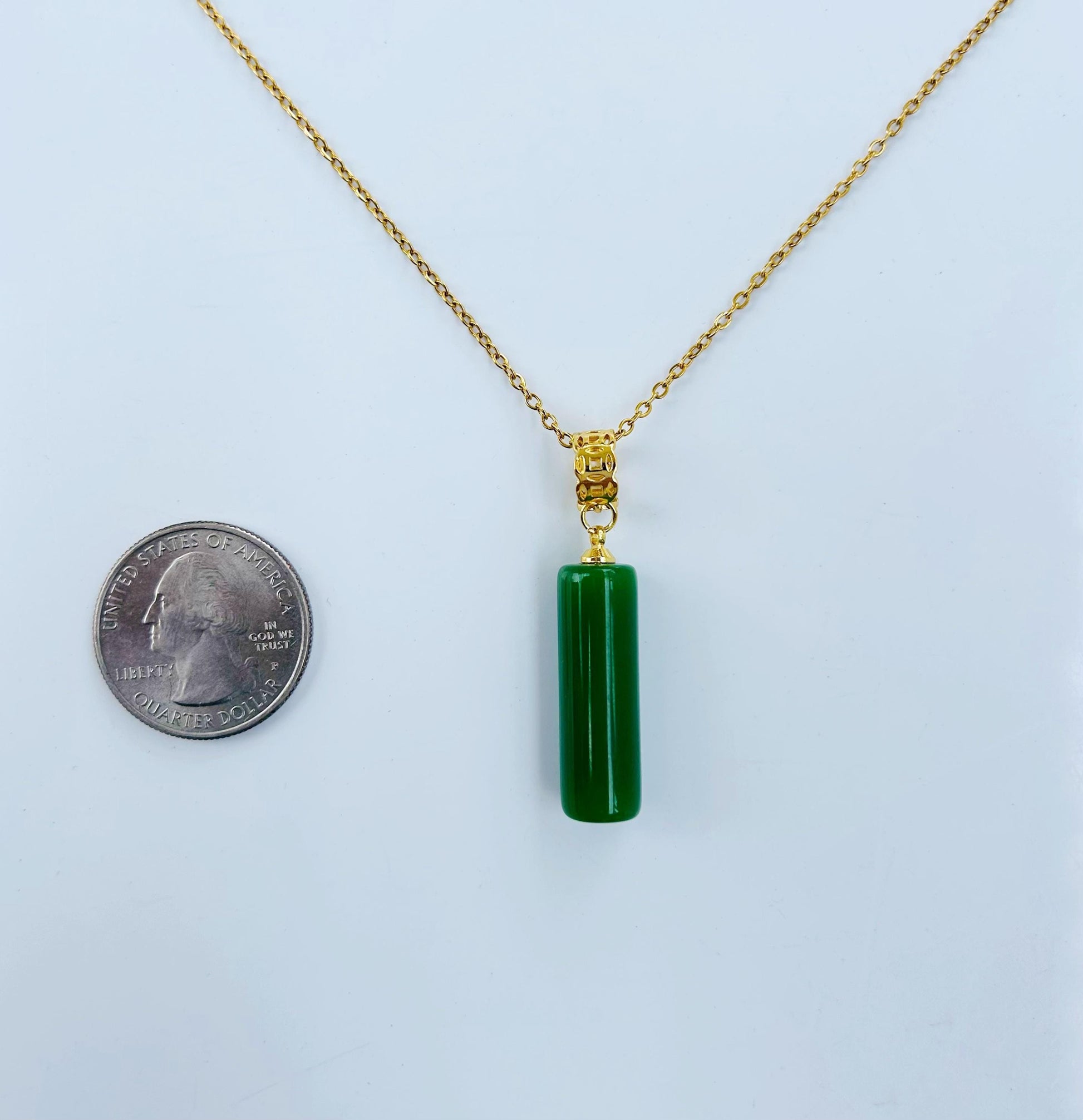 Green jade pillar necklace shown next to a US quarter coin for size comparison
