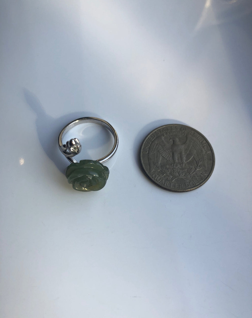 Jade rose ring shown next to coin for size reference