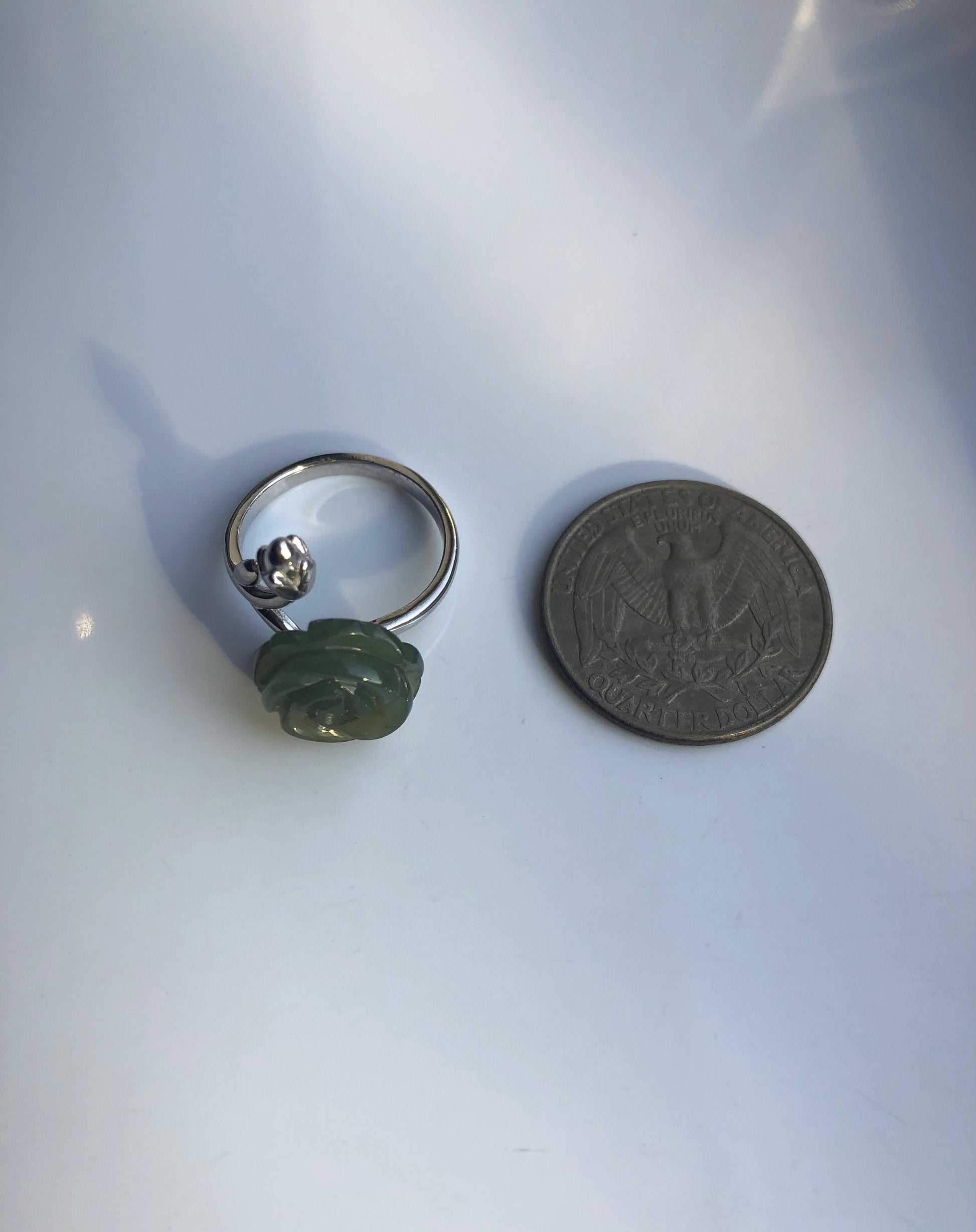 Jade rose ring shown next to coin for size reference