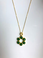 An 18k gold plated hexagonal pendant necklace with natural green jade beads and a star pattern.