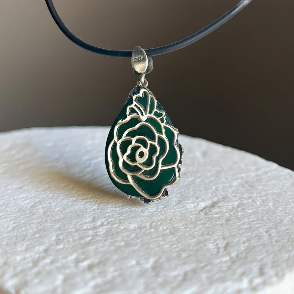 the back of a jade floral pendant