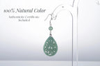 Close-up of authentic jade teardrop earrings with intricate silver vintage frame