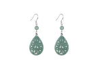 A pair of light green jade teardrop earrings with intricate cut-out patterns, suspended from silver hooks.