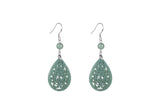 A pair of light green jade teardrop earrings with intricate cut-out patterns, suspended from silver hooks.