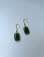 Back view of rectangular jade gemstone earrings showing polished jade surface