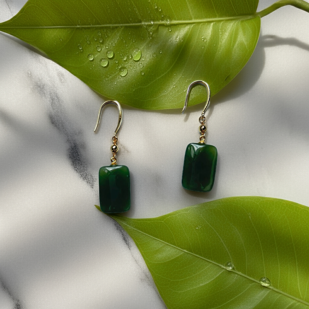dark green jade cube drop earrings with gold hooks between two leaves