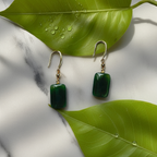 dark green jade cube drop earrings with gold hooks between two leaves