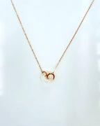 Close-up of genuine white jade circle pendant on delicate rose gold chain

