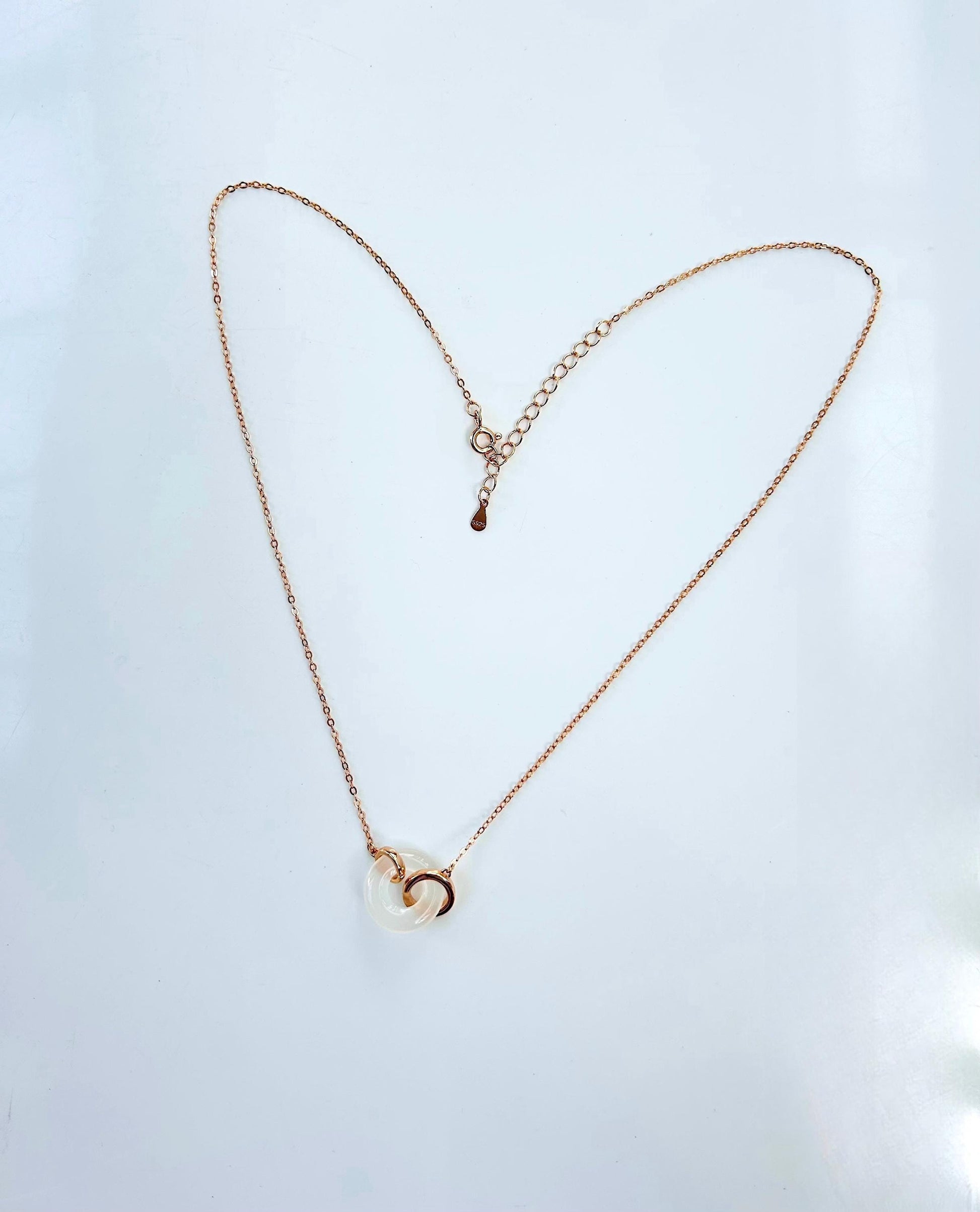 full angle showing all the polished white jade circle pendant and rose gold chain