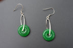 Close-up of round green jade earrings showing natural stone texture and silver hardware