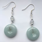 Sage green jade donut earrings in sterling silver dangle style, front view